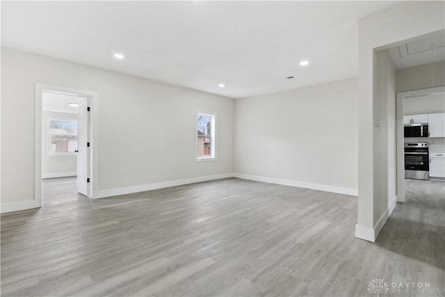 unfurnished room featuring light hardwood / wood-style floors and a wealth of natural light