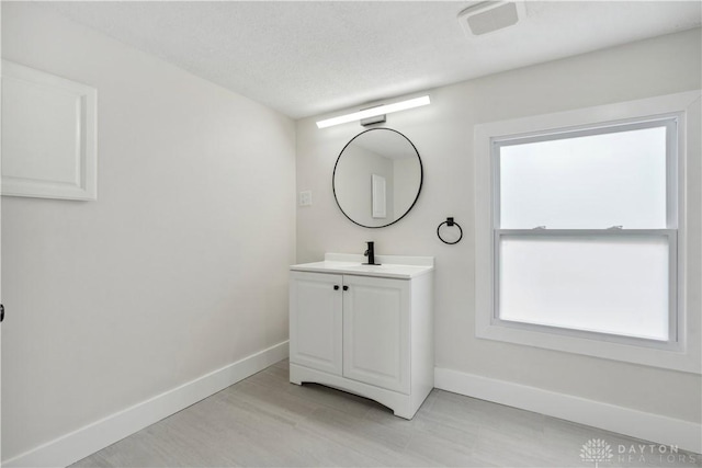 bathroom featuring vanity and a textured ceiling