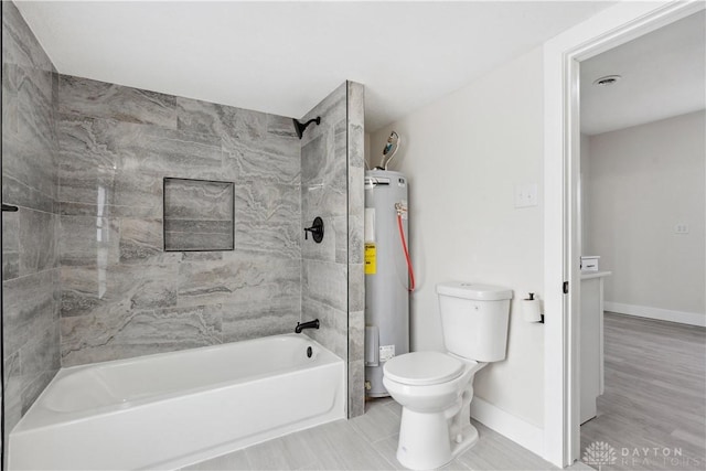 bathroom featuring water heater, tiled shower / bath, and toilet