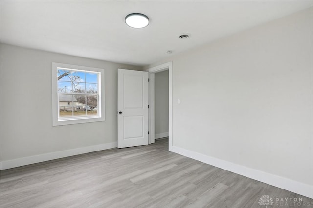 unfurnished room with light hardwood / wood-style flooring