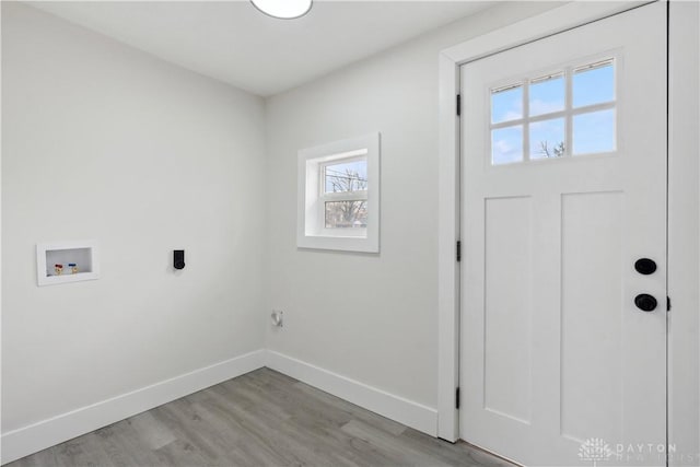 laundry area featuring washer hookup, light hardwood / wood-style floors, and hookup for an electric dryer