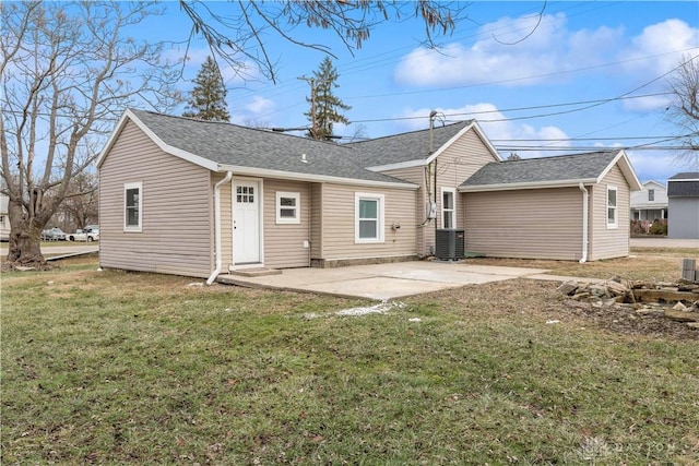 back of house featuring central AC, a patio, and a lawn