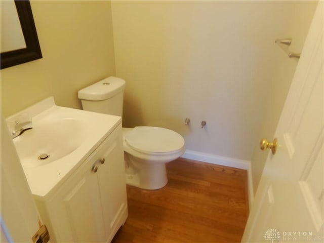 bathroom featuring hardwood / wood-style flooring, vanity, and toilet