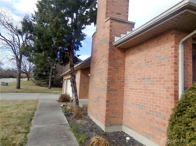 view of side of property featuring a garage and a yard