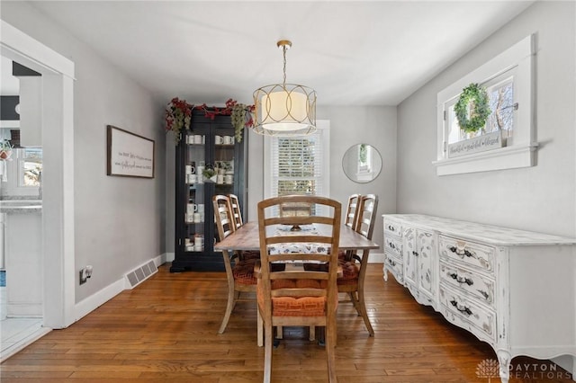 dining area with dark hardwood / wood-style flooring