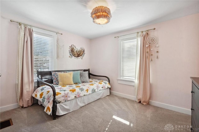 bedroom featuring light colored carpet