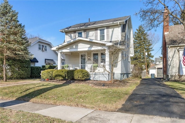 view of front of property with a porch and a front yard