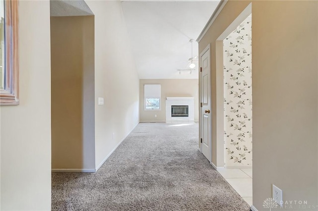 hallway featuring light carpet and lofted ceiling