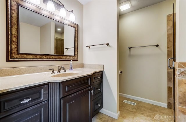 bathroom with vanity and a shower with shower door