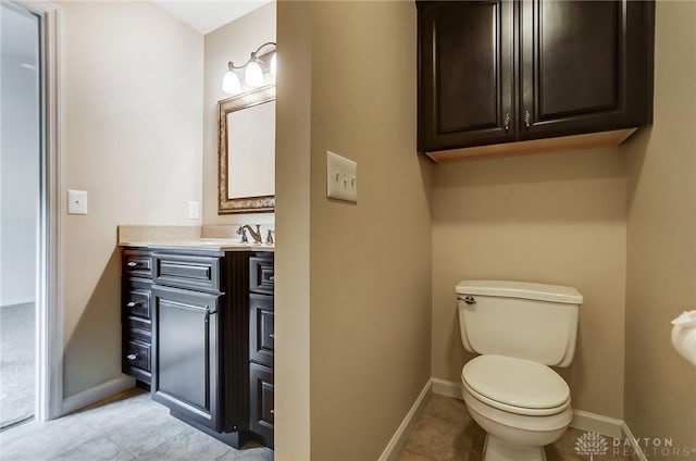 bathroom with vanity, tile patterned flooring, and toilet