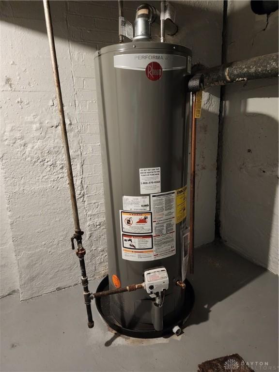 utility room featuring water heater