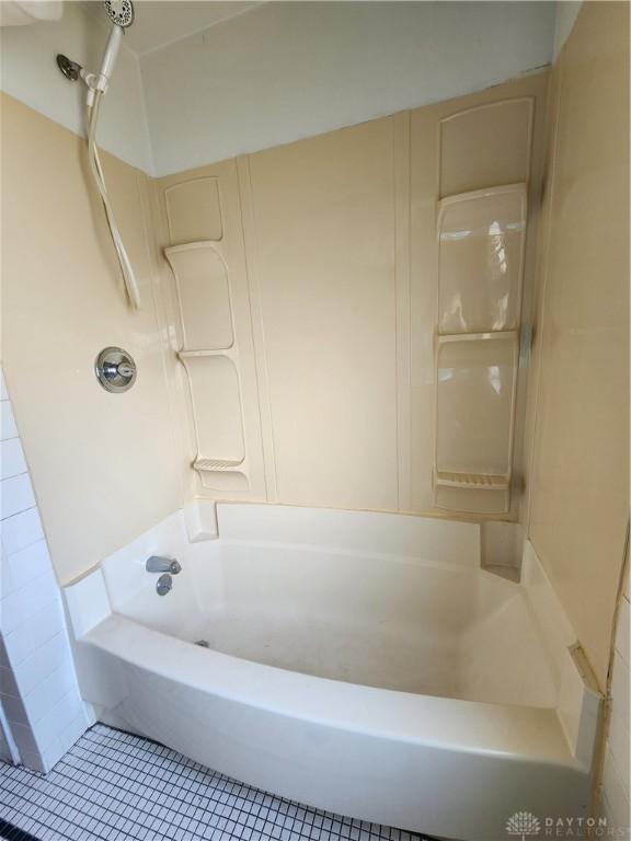 bathroom with tile patterned flooring and tub / shower combination