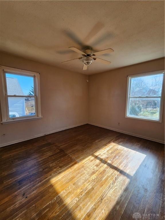 unfurnished room featuring ceiling fan and dark hardwood / wood-style flooring