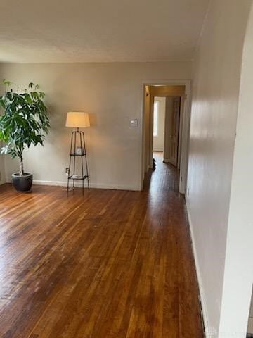 unfurnished room with dark hardwood / wood-style floors