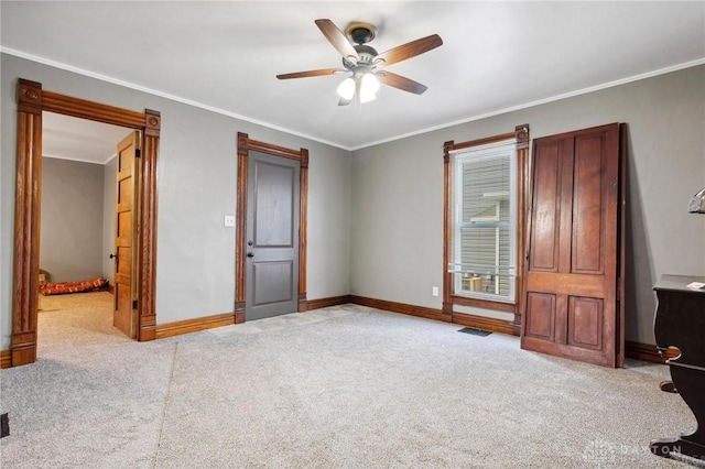 bedroom featuring ornamental molding, light carpet, and ceiling fan