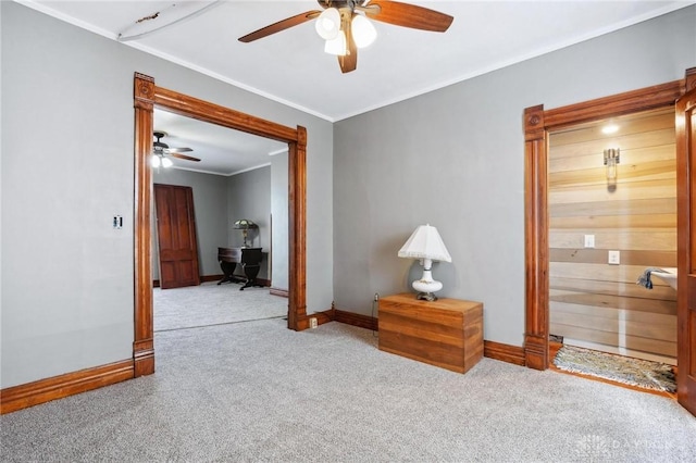 carpeted empty room featuring crown molding and ceiling fan