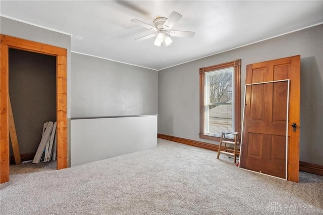 interior space with ceiling fan and carpet floors