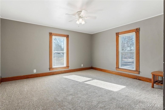 carpeted spare room with ceiling fan