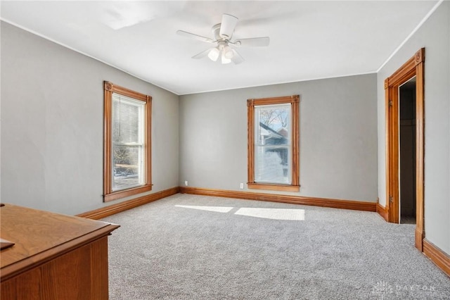 interior space featuring light carpet and ceiling fan