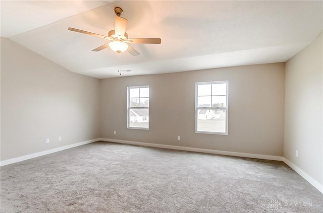 spare room with lofted ceiling, carpet floors, and ceiling fan