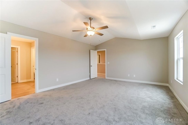 carpeted empty room with lofted ceiling and ceiling fan