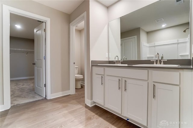 bathroom featuring hardwood / wood-style flooring, vanity, and toilet