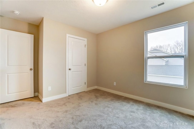 unfurnished bedroom featuring light colored carpet