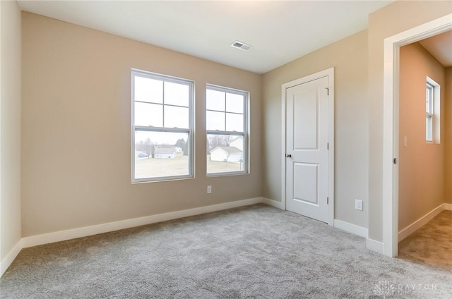 unfurnished bedroom featuring light carpet