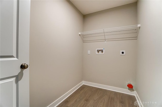 laundry area featuring electric dryer hookup, dark hardwood / wood-style floors, and washer hookup