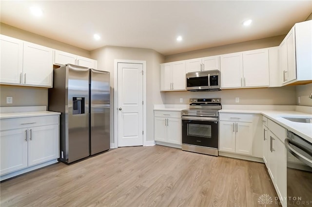 kitchen with white cabinetry and appliances with stainless steel finishes