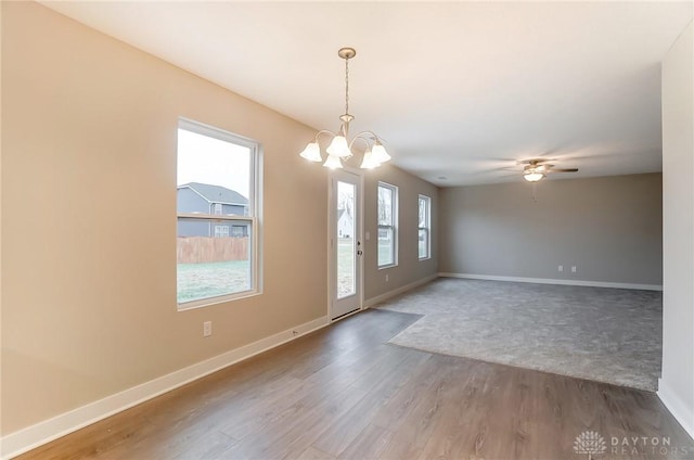 entryway with hardwood / wood-style floors and ceiling fan with notable chandelier