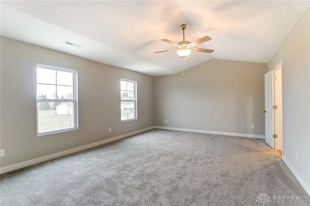 carpeted spare room featuring ceiling fan and lofted ceiling