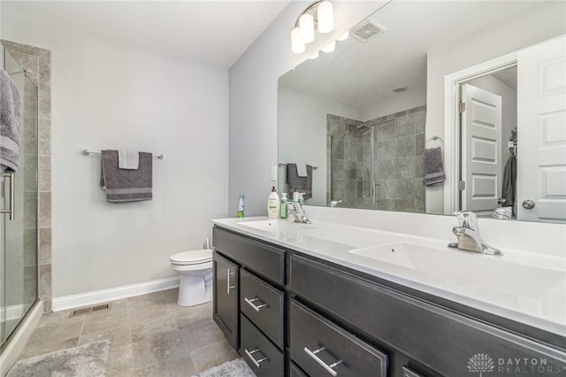 bathroom with an enclosed shower, vanity, and toilet