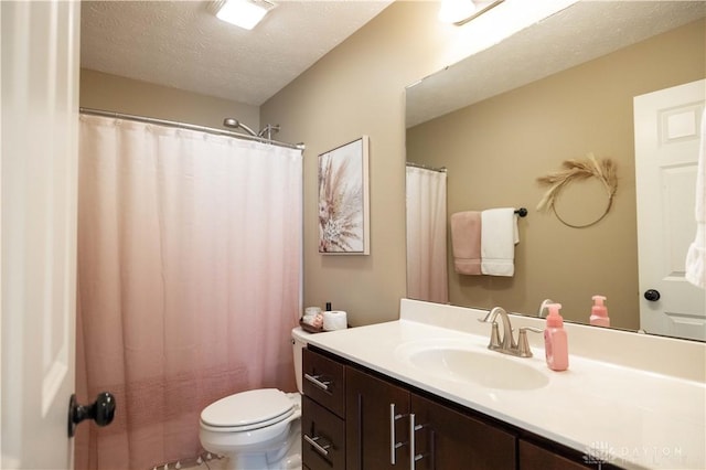 bathroom with vanity, toilet, and a textured ceiling