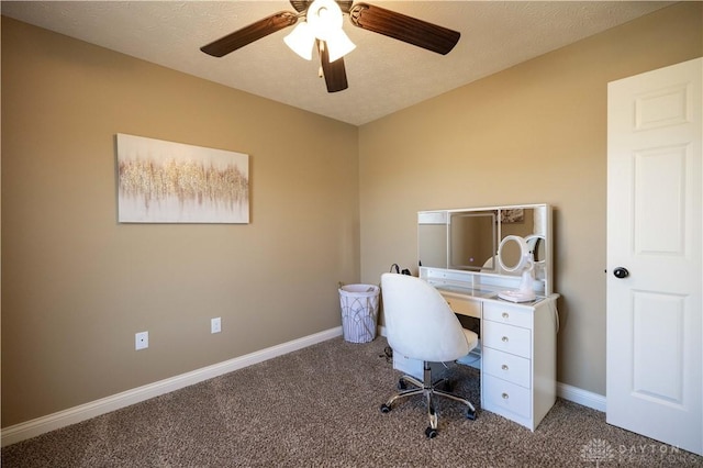 unfurnished office featuring ceiling fan, carpet, and a textured ceiling