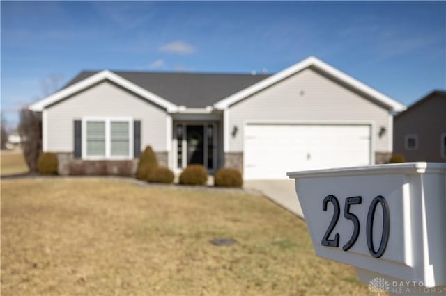 ranch-style home with a garage and a front yard