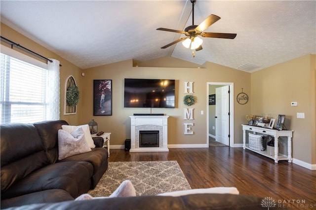 living room with ceiling fan, lofted ceiling, and dark hardwood / wood-style flooring