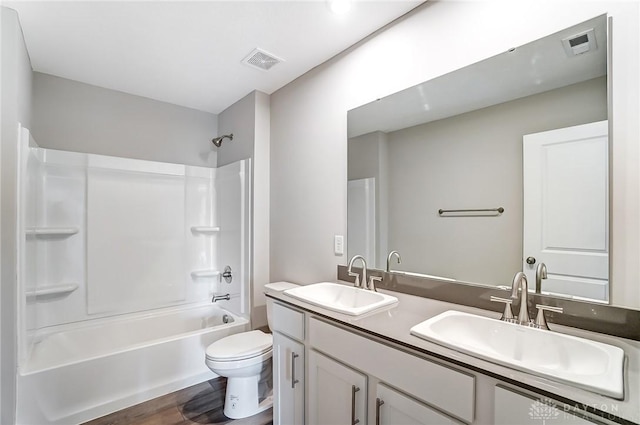 full bathroom with vanity, wood-type flooring, shower / washtub combination, and toilet