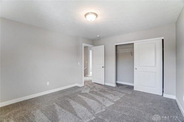 unfurnished bedroom featuring carpet floors and a closet