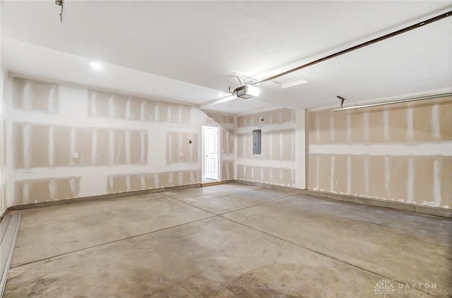 garage with a garage door opener and electric panel