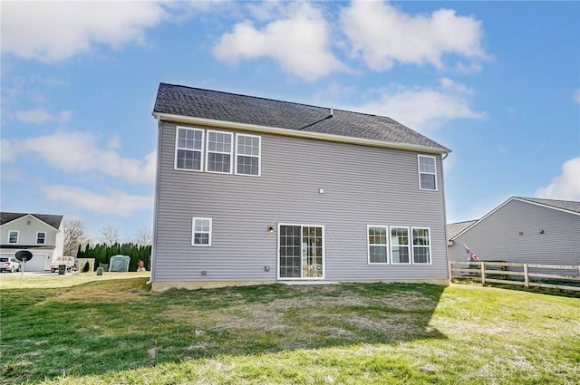 rear view of property with a lawn