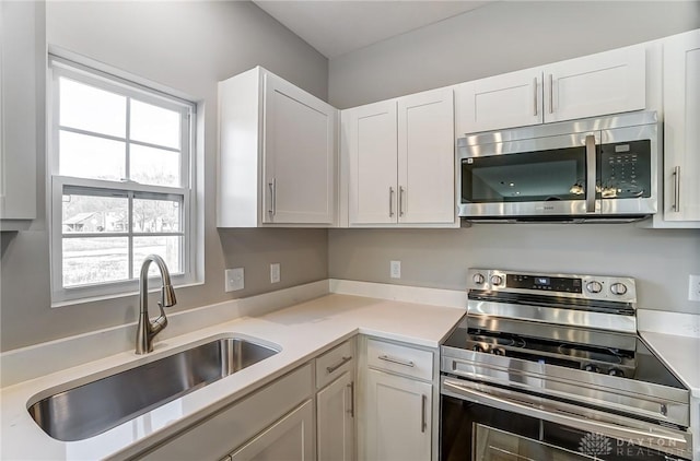 kitchen featuring white cabinetry, appliances with stainless steel finishes, and sink