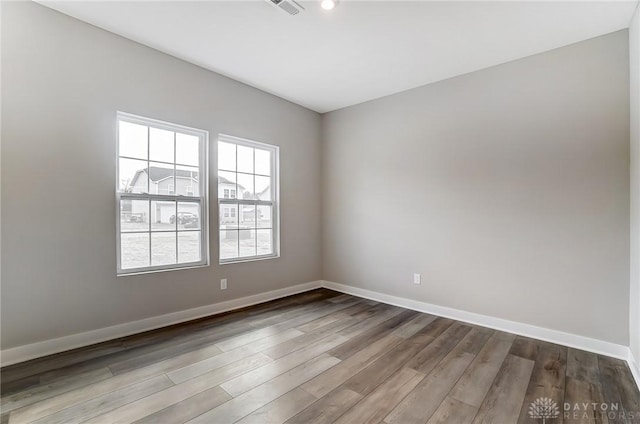 unfurnished room with hardwood / wood-style flooring