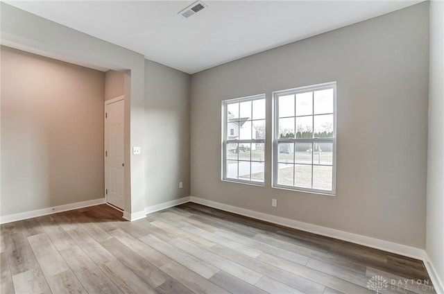 spare room with light hardwood / wood-style floors