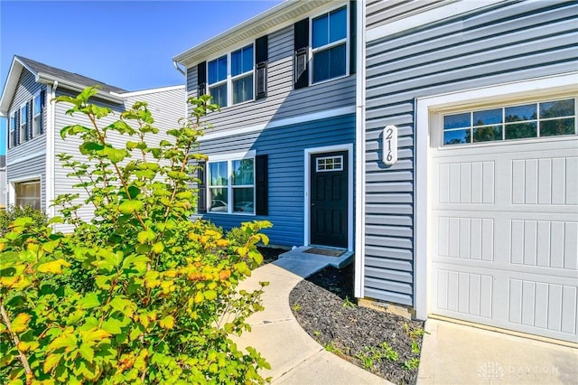 view of exterior entry with a garage