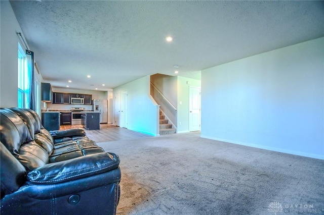 living room featuring a textured ceiling and carpet flooring