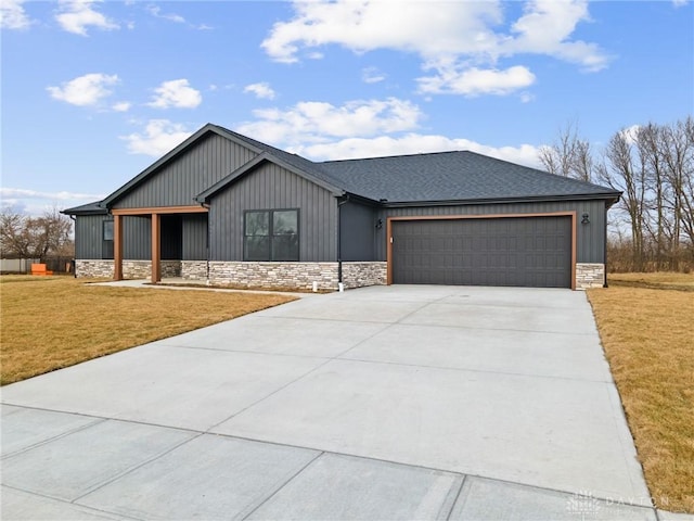 view of front of home with a garage and a front yard