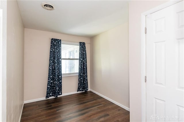 unfurnished room with dark hardwood / wood-style floors