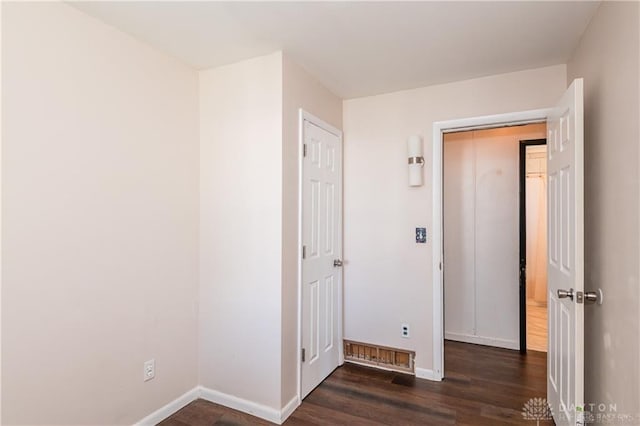 corridor featuring dark hardwood / wood-style flooring