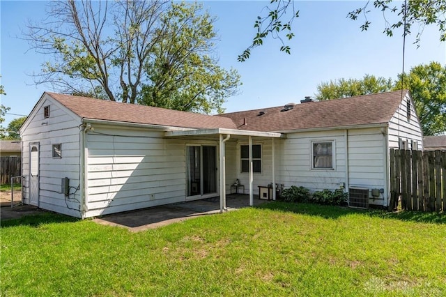 rear view of house featuring a yard, cooling unit, and a patio area